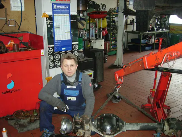 Mitarbeiter mit ausgebauter Hinterachse